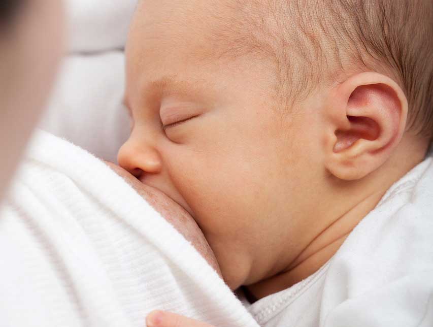 Baby Breastfeeding with eyes closed